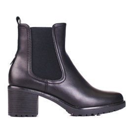 Botas Shelovet Chelsea negras en un poste negro