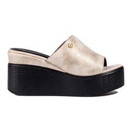 Chanclas metálicas en una cuña alta dorada dorado