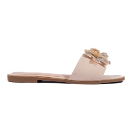 Chanclas de mujer beige con decoración.
