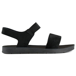 Sandalias de ante negro con banda elástica y suela plana.