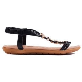 Sandalias planas de mujer negras con adornos. negro