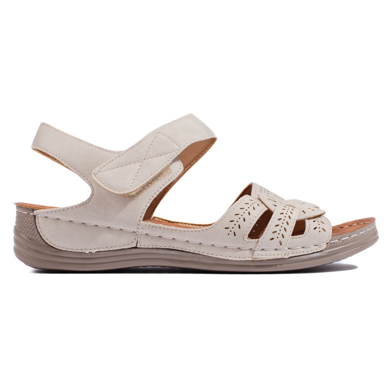 Sandalias de mujer beige claro con cuña baja.