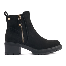 Botines de mujer negros con cremallera decorativa.