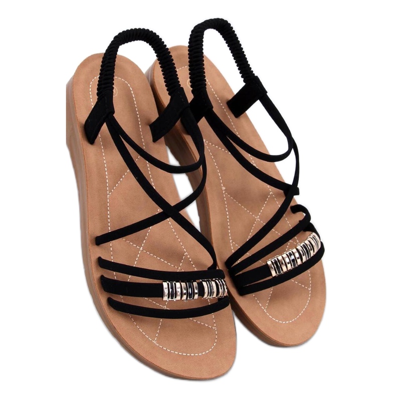 Sandalias minimalistas sobre una delicada plataforma negra. negro