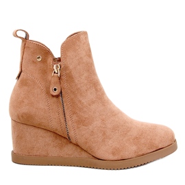Botas aislantes de camello aisladas en cuñas beige Botas aislantes de camello aisladas en cuñas beige