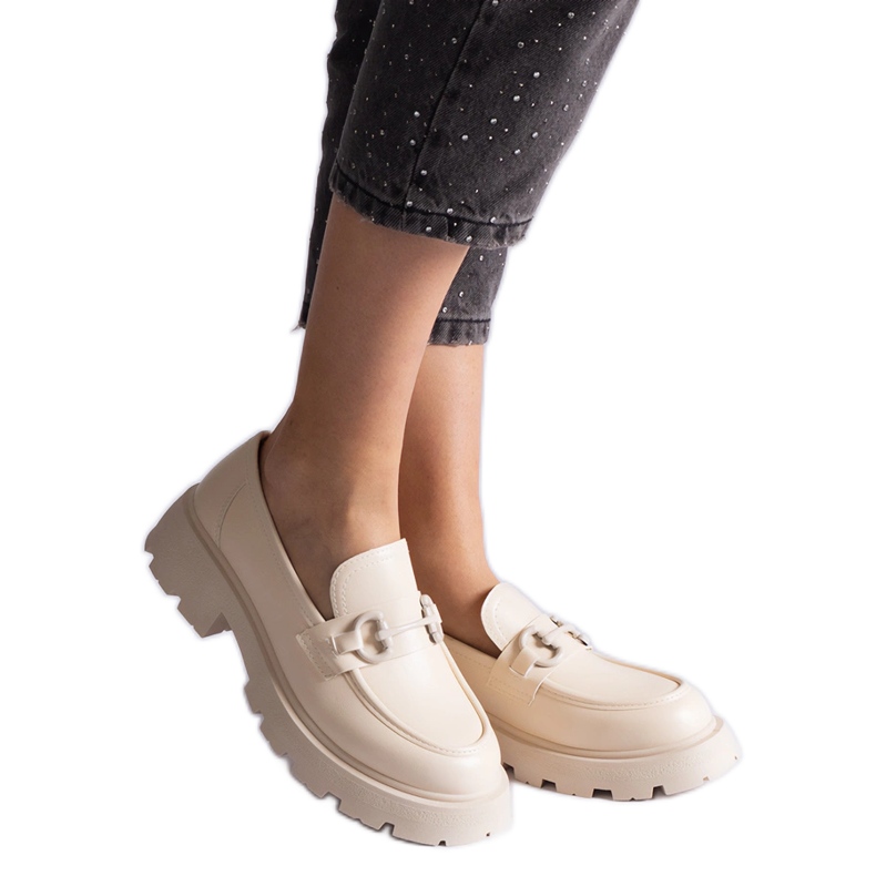 Mocasines de ecopiel beige con decoración dorada.
