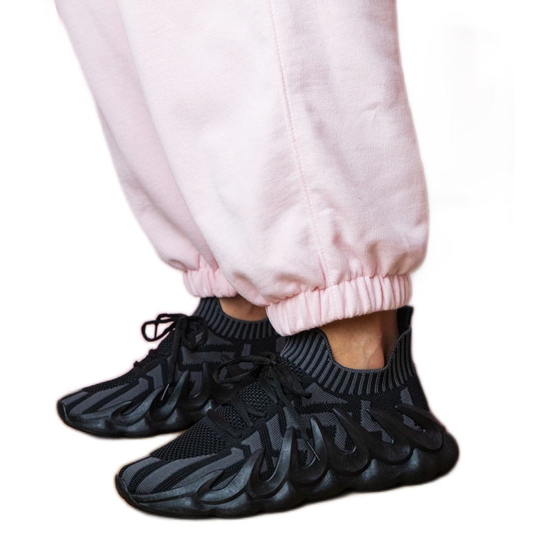 Zapatillas de deporte de deportes negros en una suela masiva
