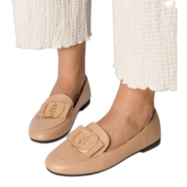 Mocasines para mujeres cremosas con una decoración dorada cremoso
