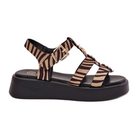 Sandalias de mujeres en la plataforma con un detalle dorado de la cebra de color negro beige