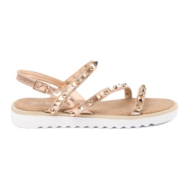 Sandalias de mujeres doradas con tachuelas dorado