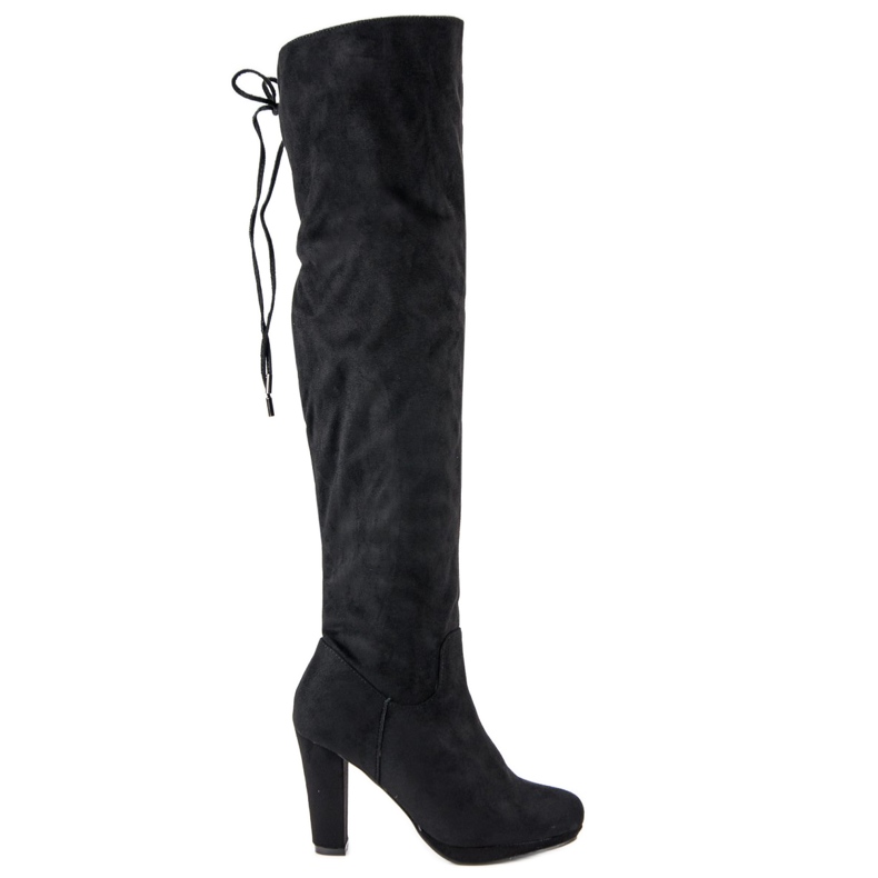 Botas de muslo de ante en el poste negro
