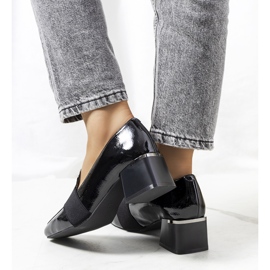 Zapatos lacados en negro en el puesto de Tammy. 2