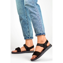 Sandalias de ante negro con banda elástica y suela plana. 3