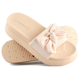 Zapatillas de mujer beige con lazo sobre suela gruesa. 4