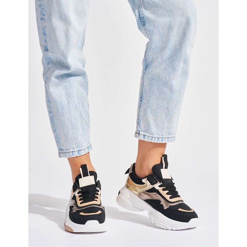 Zapatillas negras y doradas con suela gruesa. negro 1