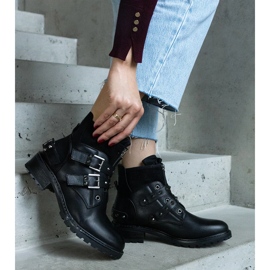 Botines negros decorados con tachuelas y tacón plano. 1