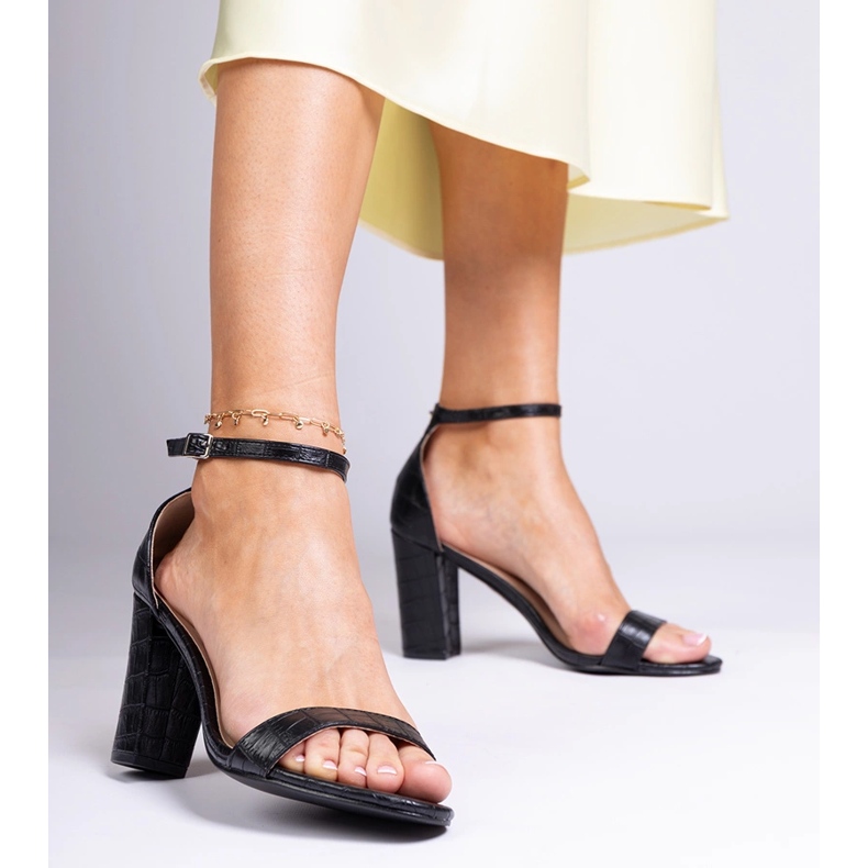 Sandalias negras en el poste negro 1