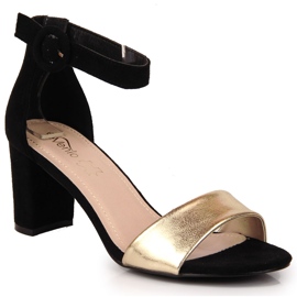 Sandalias de mujer negras y doradas en el puesto eVento. 4